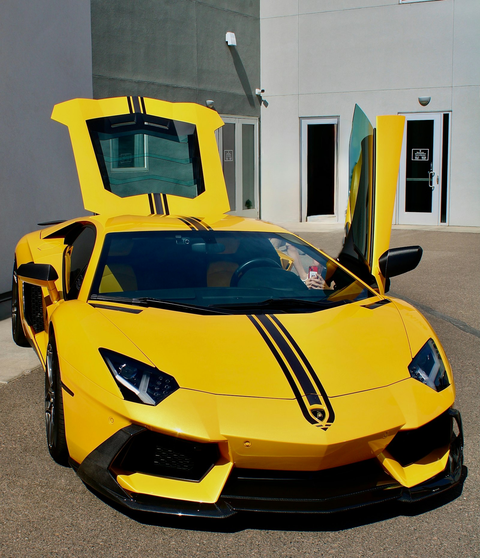 A yellow supercar with doors open